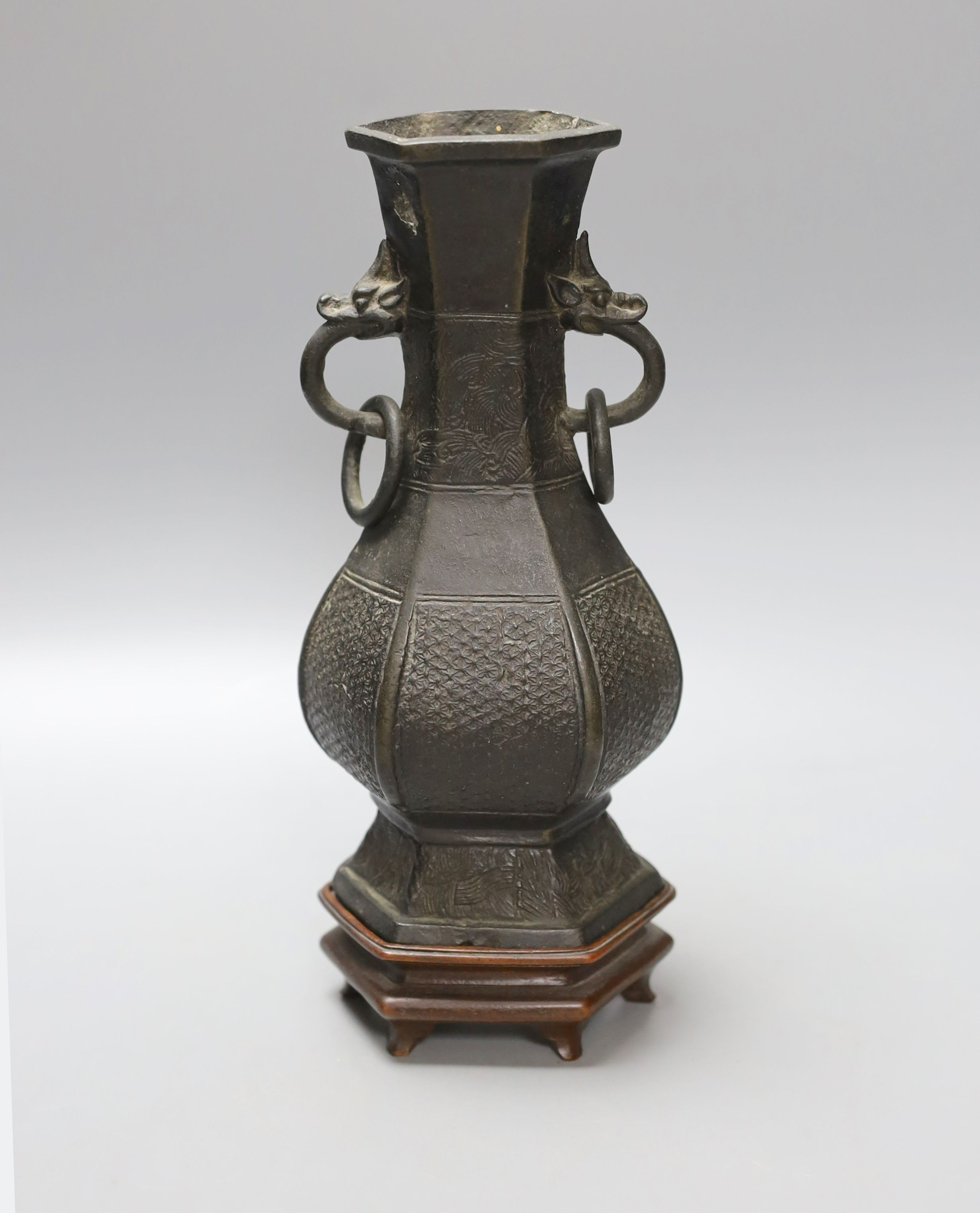 A Chinese bronze vase with ring handles, Song/Yuan Dynasty, on hardwood stand, 24cm total height